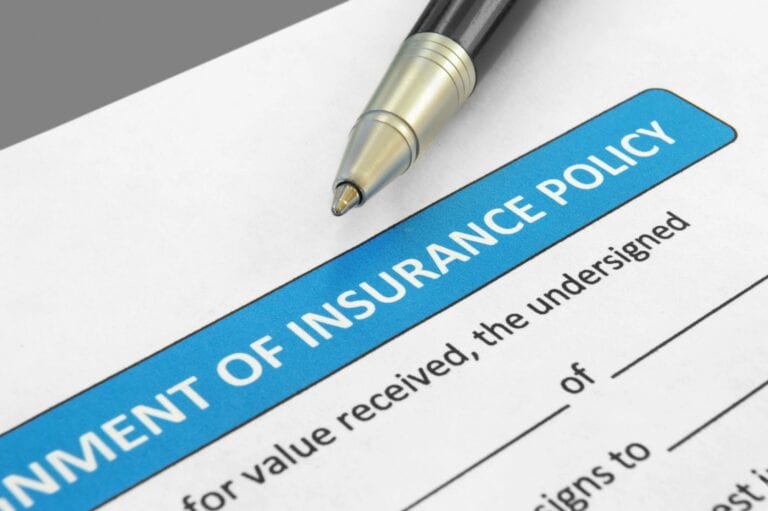 Insurance policy document with pen